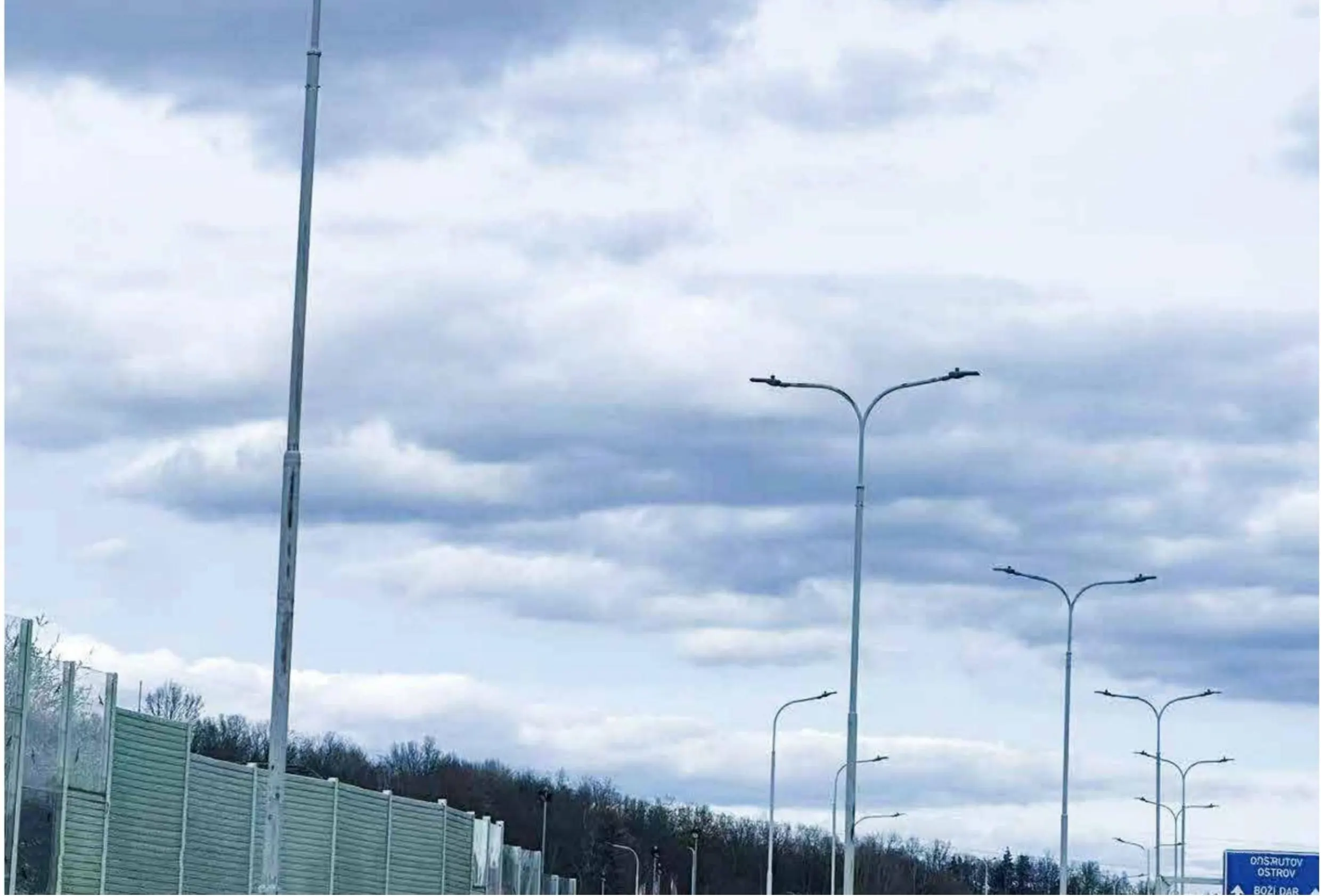 Road lighting installation along a highway